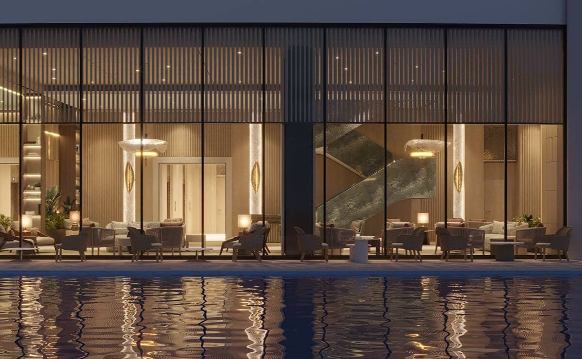Contemporary poolside lounge at Shang Bauhinia Residences with floor-to-ceiling glass walls, refined interiors, and water reflections