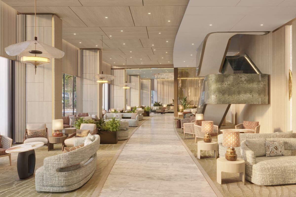Elegant Shang Bauhinia Residences lounge with warm lighting, refined seating, indoor greenery, and a sculptural staircase