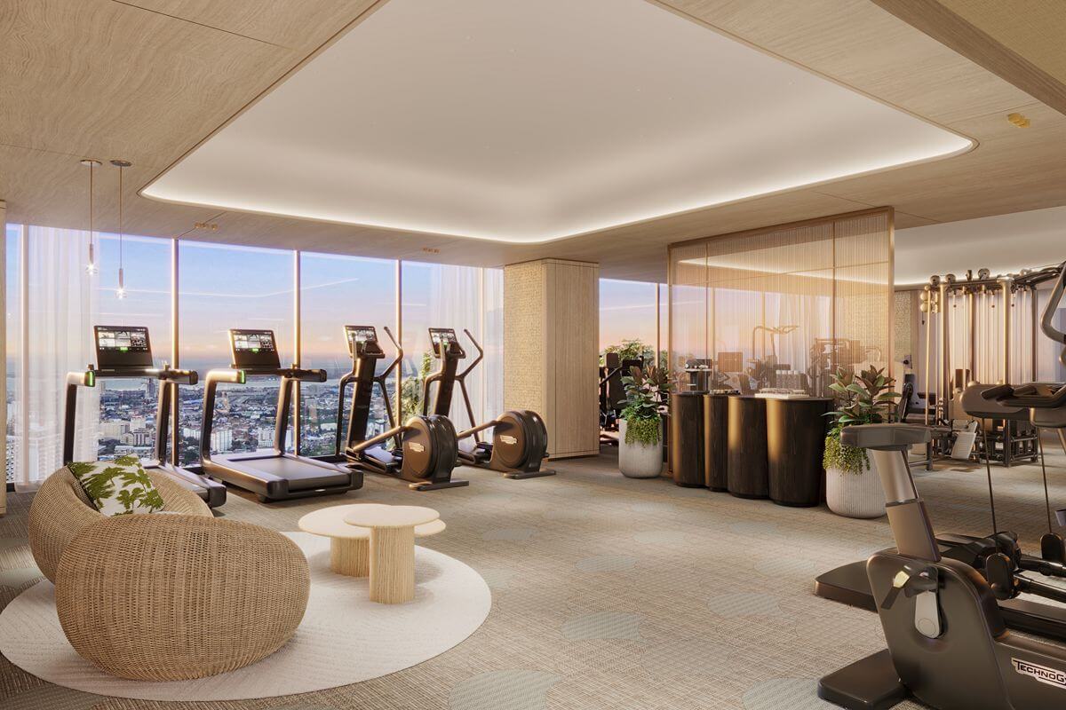 Bright fitness center at Shang Bauhinia Residences with treadmills, exercise equipment, lounge seating, and floor-to-ceiling windows